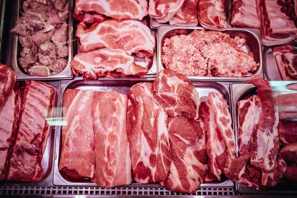 bigstock-red-raw-meat-shop-window-fres-380119393